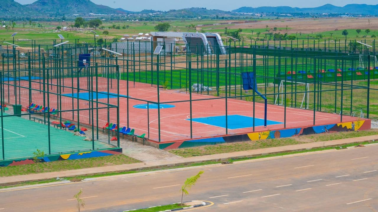Tennis courts with lush green landscaping at the estate